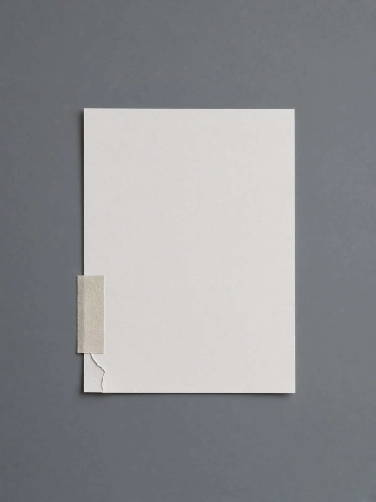 A page repaired with a strip of linen tape on a desk